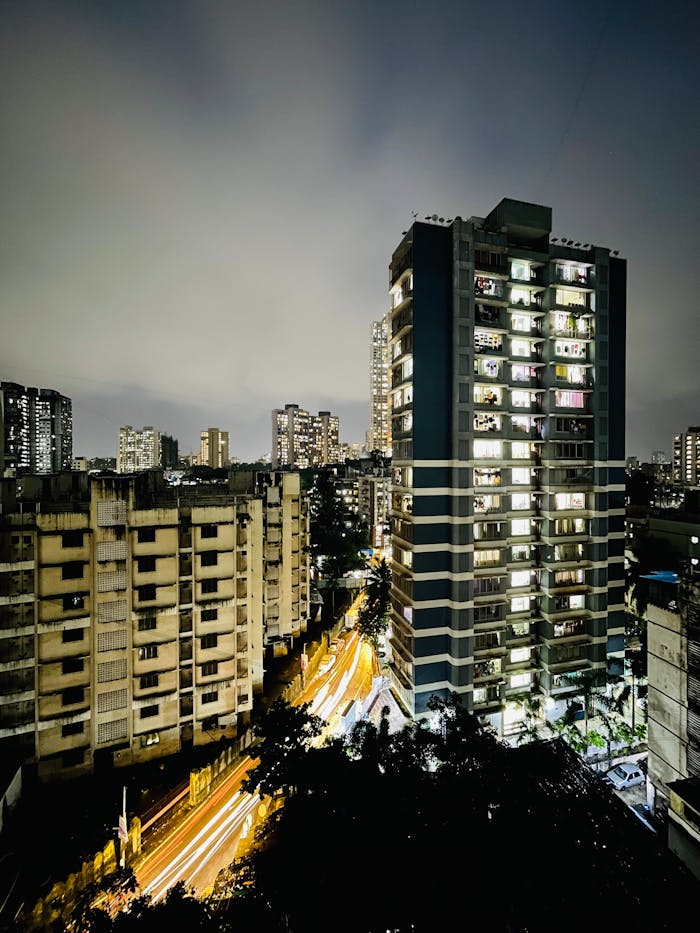 portfolio-img-05 A long exposure shot of Mumbai's modern skyline at night showcasing city lights and traffic trails.